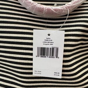 Kate Spade black and white stripe bag with pink strap and handles.